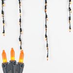 Frosted Orange 100 Light Icicle Lights Black Wire Medium Drops