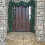 Lighted Colorado Pine garland framing a stone entryway