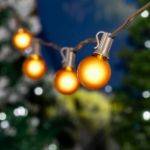 25 G40 Globe String Light Set with Yellow Satin Bulbs on Brown Wire