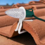 White C9 Tuff Tile Clip installed on terracotta tile roof
