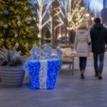 Blue and silver 3D gift box in an outdoor holiday plaza
