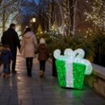 Green and white 3D gift box along a municipal holiday walkway