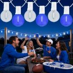 Blue and Pure White LED filament G40 globe string lights glowing over an outdoor game day gathering
