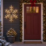 36" Deluxe LED Snowflake Warm White lit and mounted beside a front door on a snowy evening