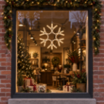 15" Traditional LED Snowflake Warm White lit and mounted displayed in a lit, decorated storefront window