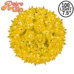Lit yellow RetroGlo starlight sphere, 7.5 inch, shown against white