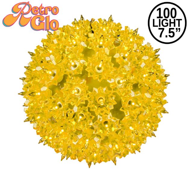 Lit yellow RetroGlo starlight sphere, 7.5 inch, shown against white