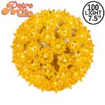 Lit gold RetroGlo starlight sphere, 7.5 inch, shown against white