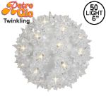 Lit clear twinkling RetroGlo starlight sphere, 6 inch, shown against white