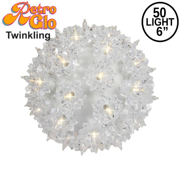 Lit clear twinkling RetroGlo starlight sphere, 6 inch, shown against white