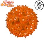 Lit orange RetroGlo starlight sphere, 6 inch, shown against white