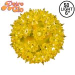 Lit yellow RetroGlo starlight sphere, 6 inch, shown against white