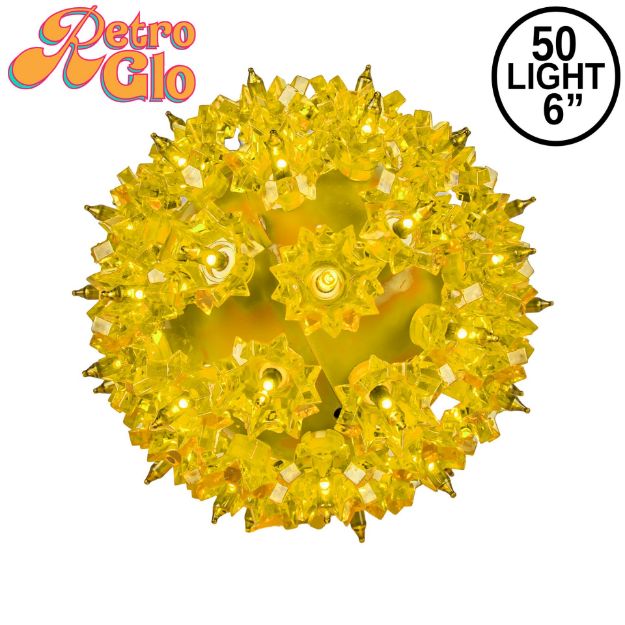 Lit yellow RetroGlo starlight sphere, 6 inch, shown against white