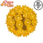 Lit gold RetroGlo starlight sphere, 6 inch, shown against white