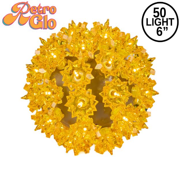 Lit gold RetroGlo starlight sphere, 6 inch, shown against white