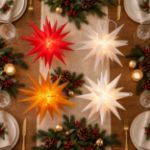 Lit Moravian stars on a decorated holiday table