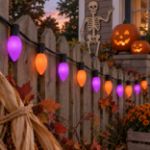 Purple and orange RetroGlo C9 Halloween lights glowing in a decorated Halloween scene