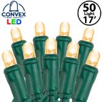 Close-up of warm white 5mm convex LED mini light bulbs on green wire