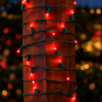 Red convex LED mini lights wrapped around an outdoor wood post