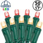 Close-up of red/warm white 5mm convex LED mini light bulbs on green wire