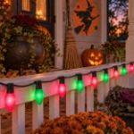 C9 Wicked Witch purple and green lights glowing on a Halloween porch
