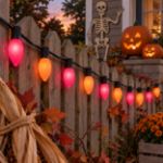C9 Trick or Treat purple and orange lights strung along a Halloween fence