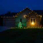 Warm White C9 Glitzer bulbs installed on a home at night