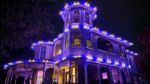 Victorian house roofline lit in purple and multicolor with Minleon RGBW C9 lights